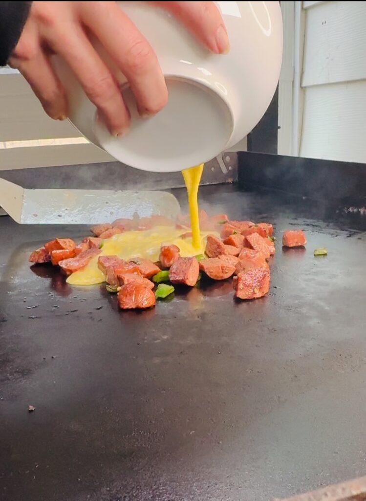 adding eggs to griddle