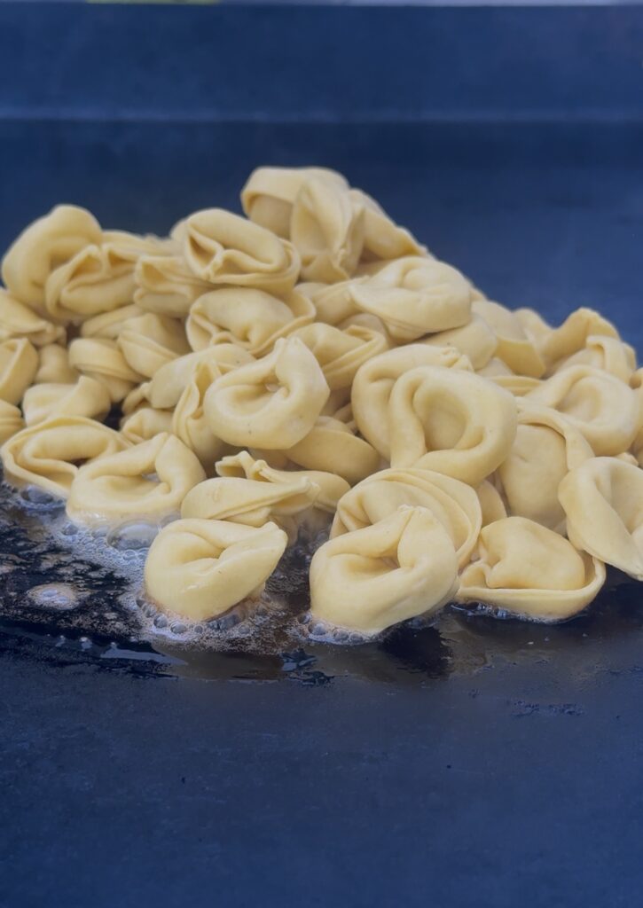 tortellini on griddle before cooking
