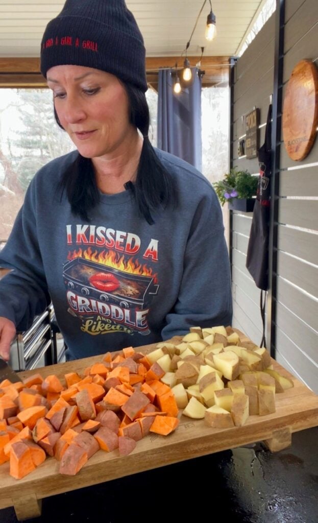 adding potatoes to the griddle