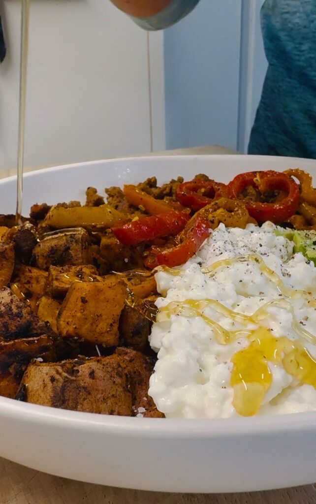 adding hot honey to  Blackstone Sweet Potato Cottage Cheese Bowl