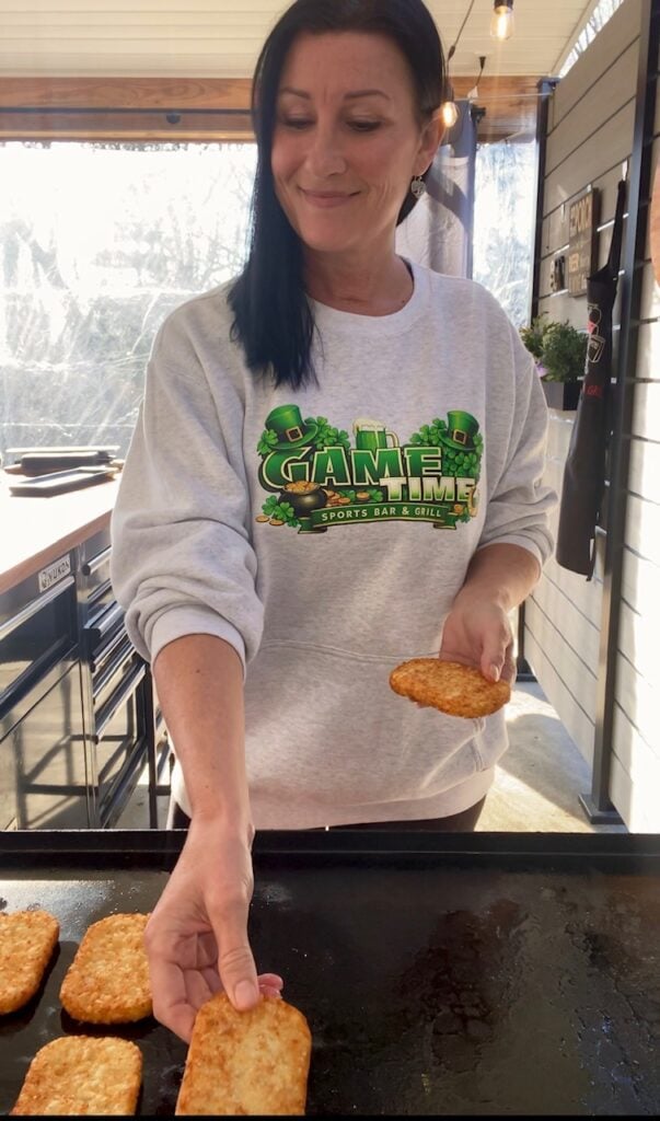 adding hash brown patty to griddle