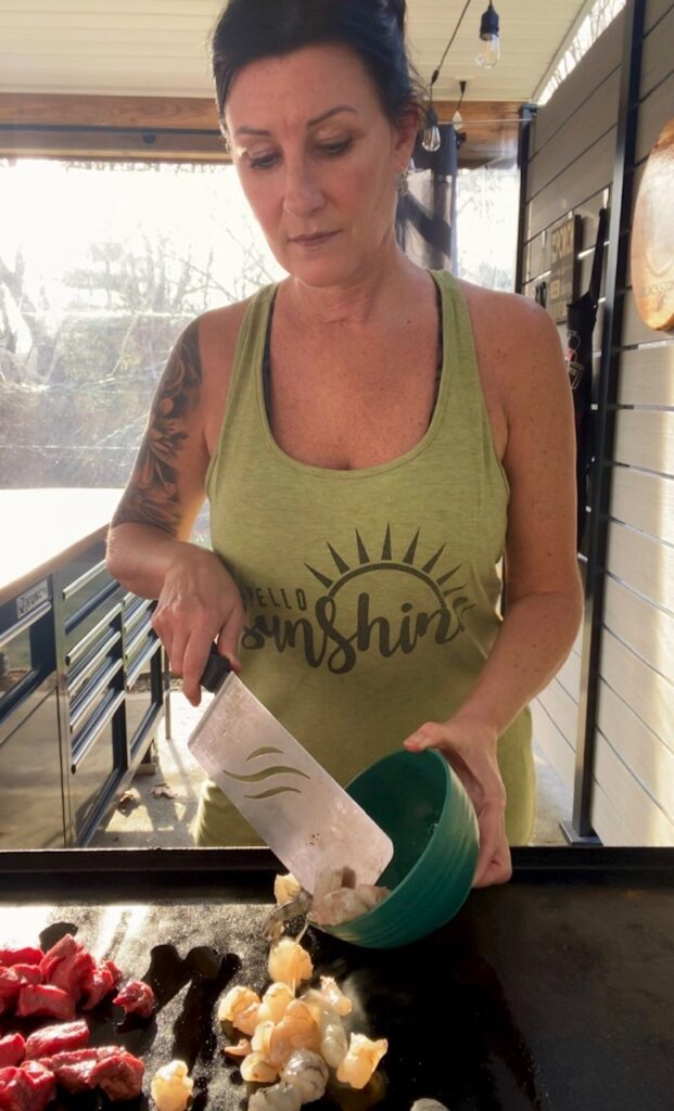 adding shrimp to the griddle