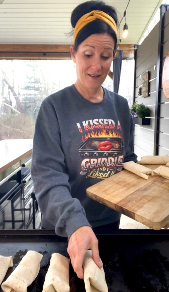 adding burritos to griddle