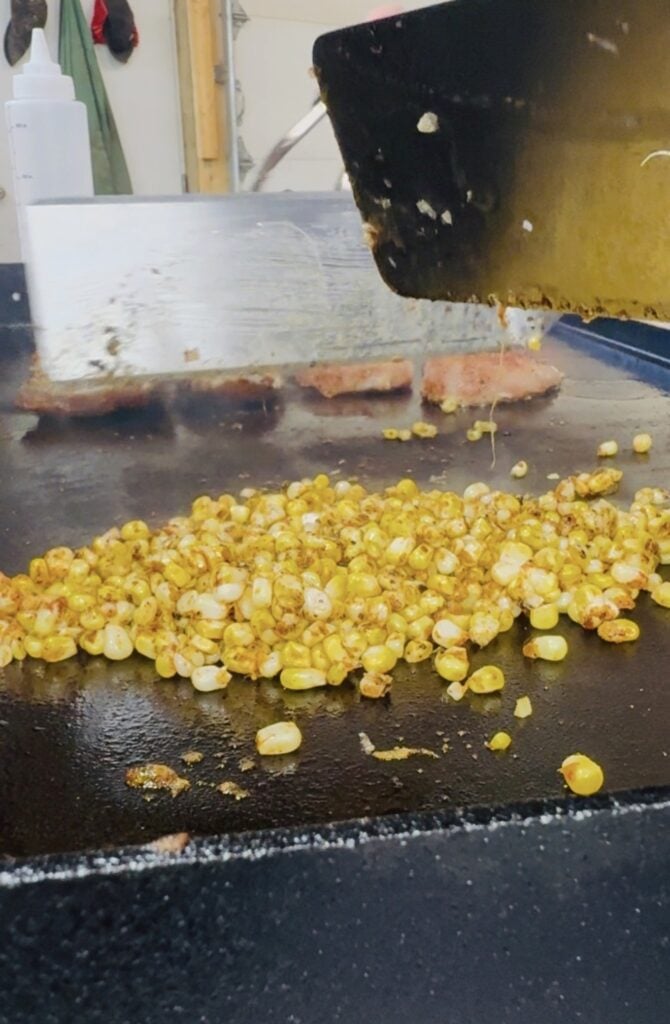 corn and chicken on the griddle