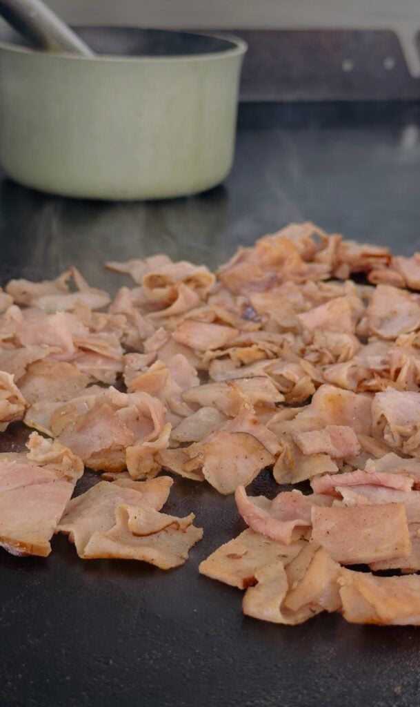 adding ham and sauce