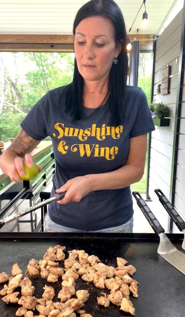 adding lime zest to Blackstone Blackberry Lime Chicken Bites