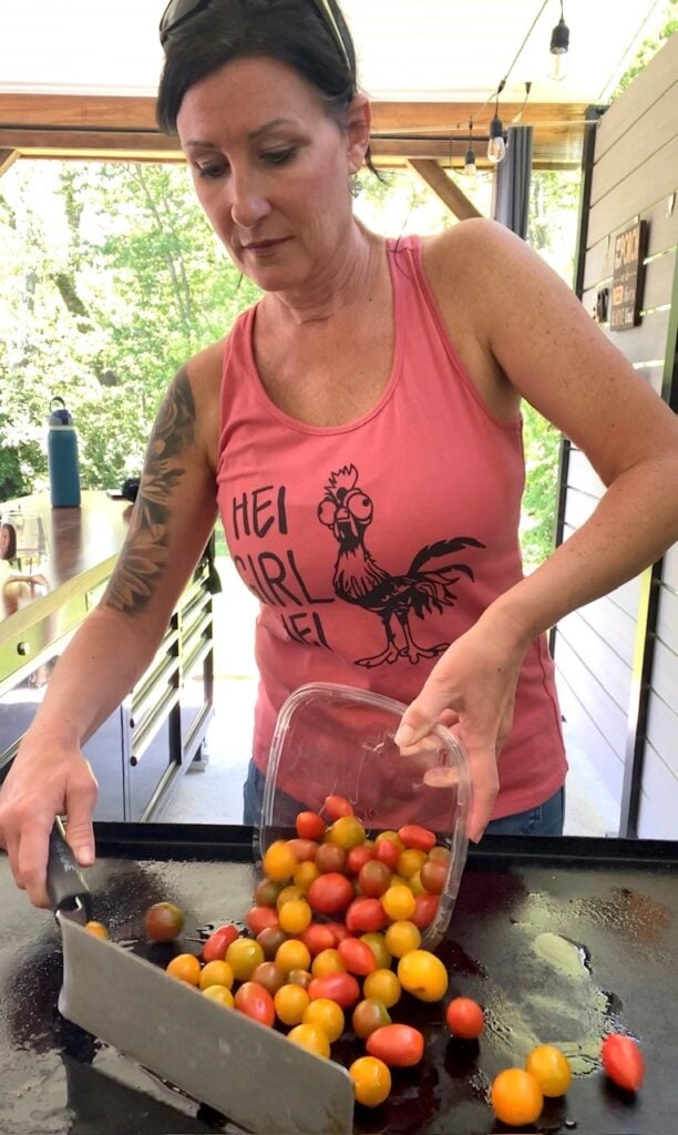 adding tomatoes to griddle