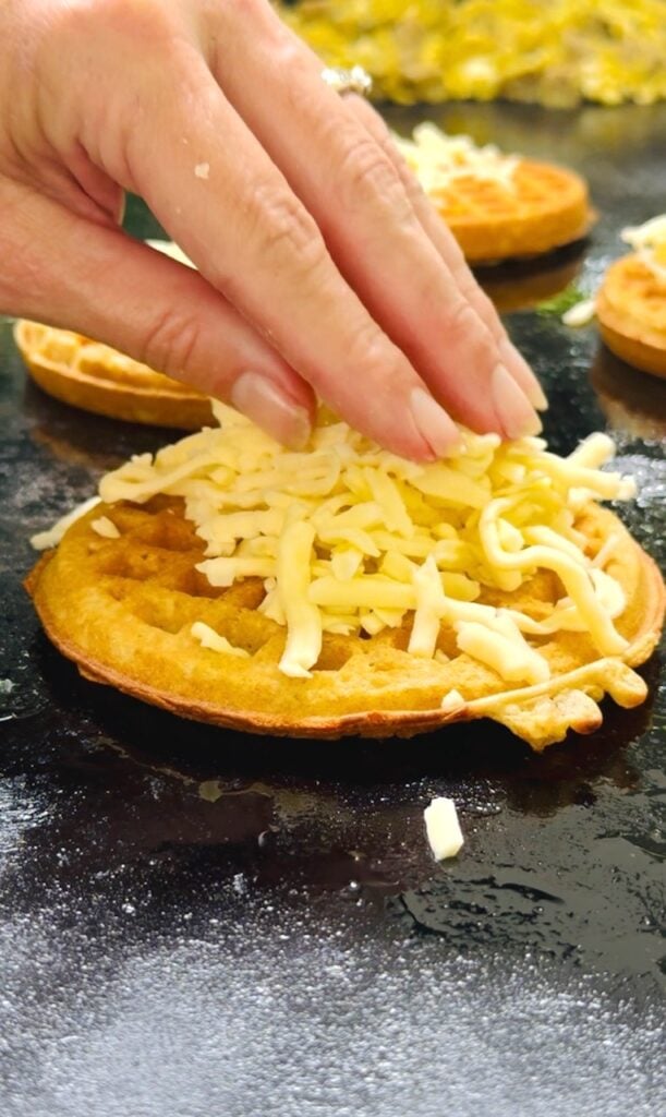 adding cheese to waffle on griddle