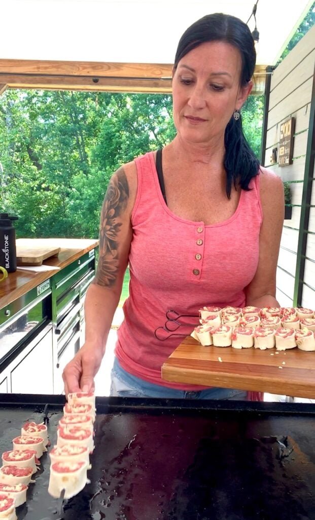 adding skewers to the griddle
