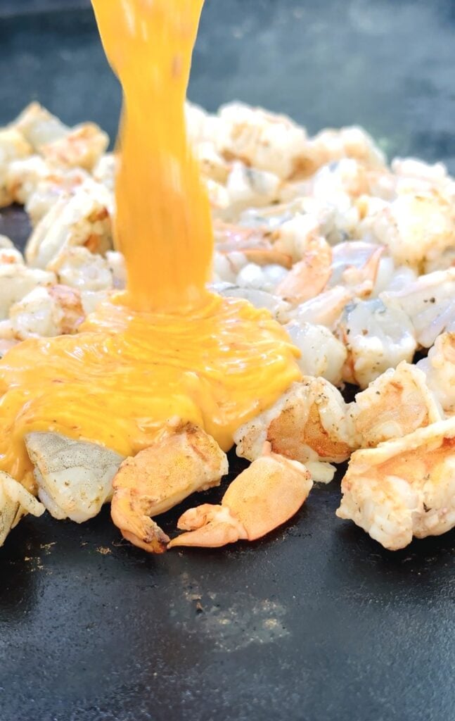 adding the sauce to the shrimp