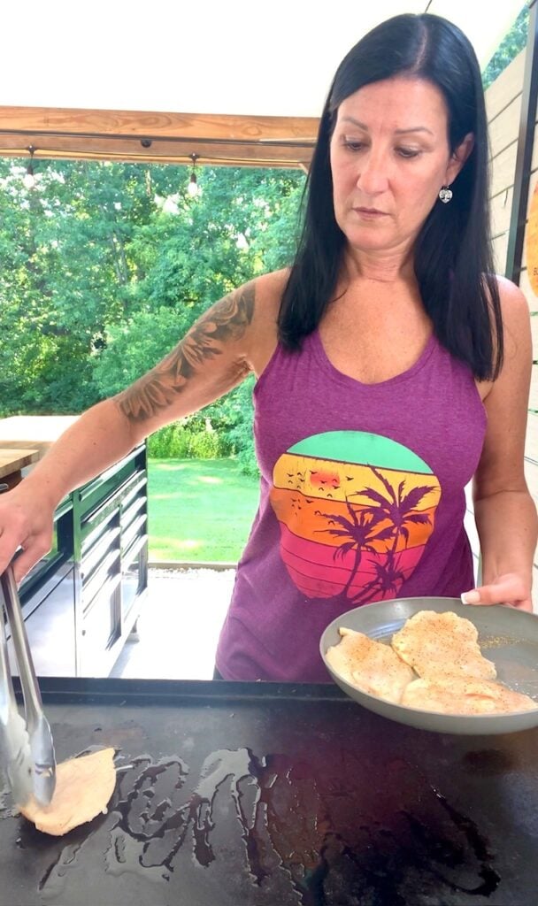 putting chicken on the griddle