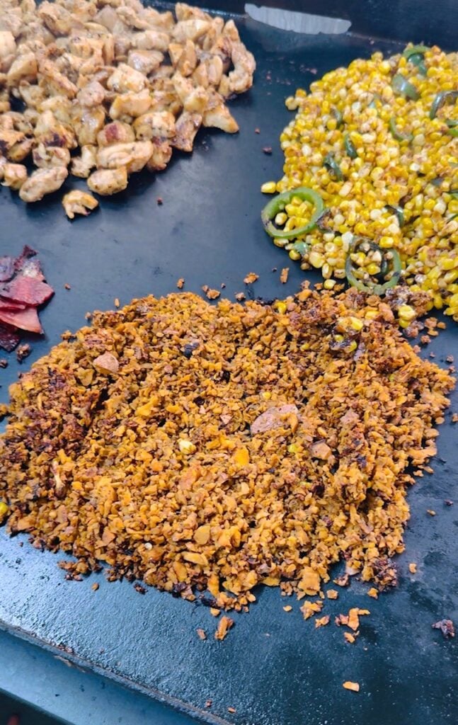 ingredients cooking on griddle
