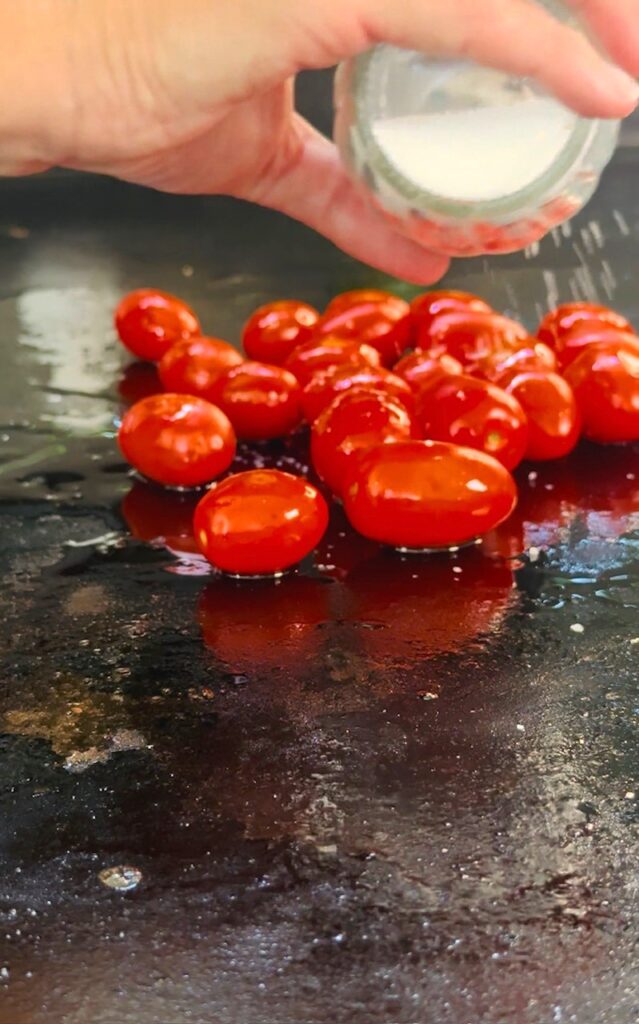 adding tomatoes to the griddle