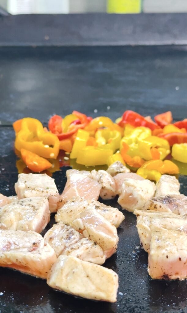 chicken and peppers on the griddle