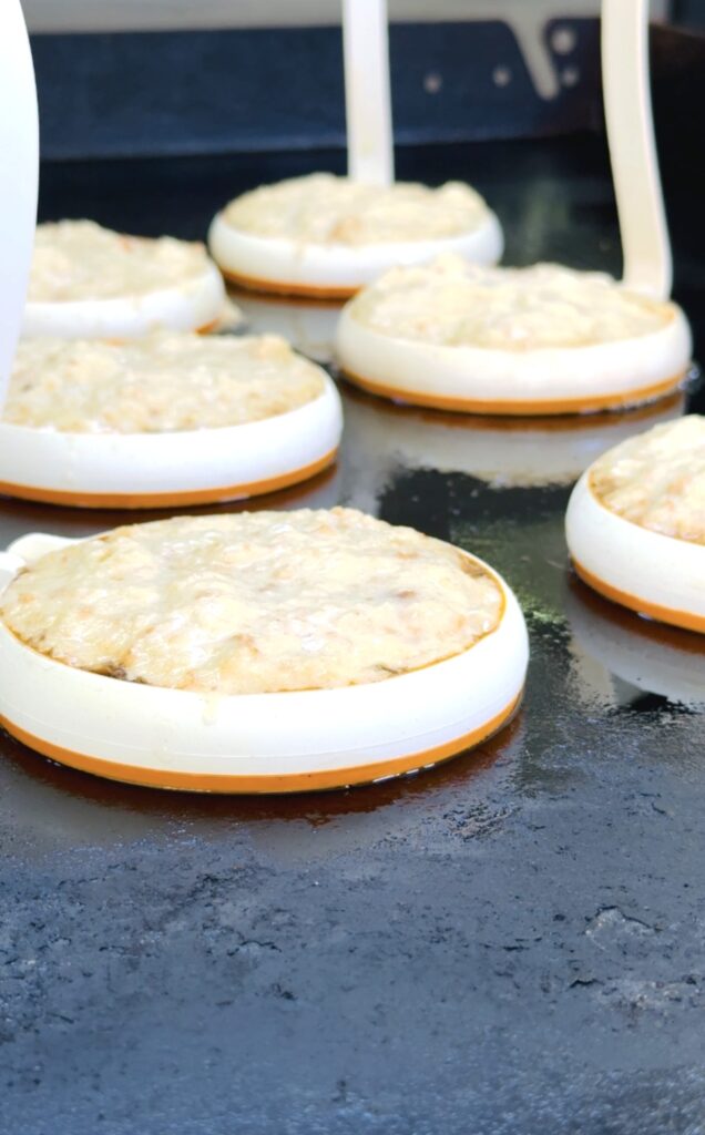 rum and cooke batter in egg rings on griddle