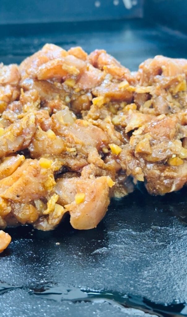 adding chicken to griddle