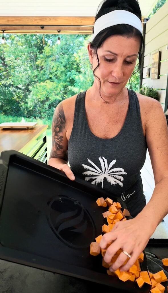 adding sweet potatoes to griddle