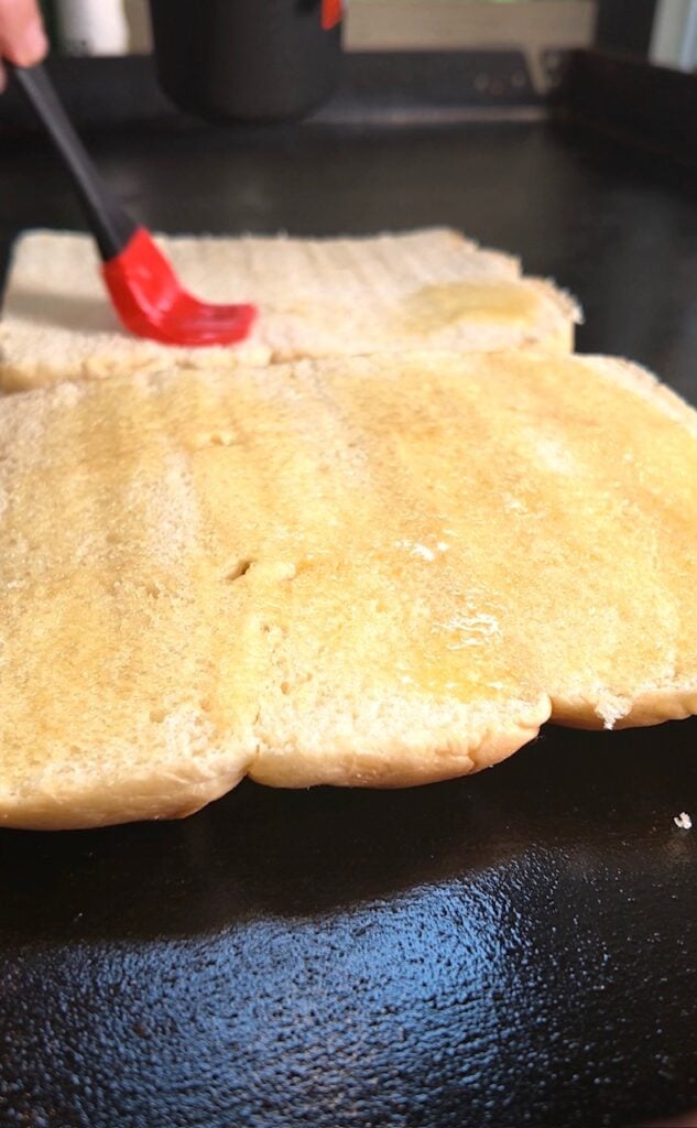 brushing butter on rolls