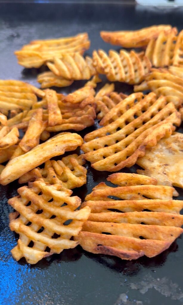 fries cooking on the griddle