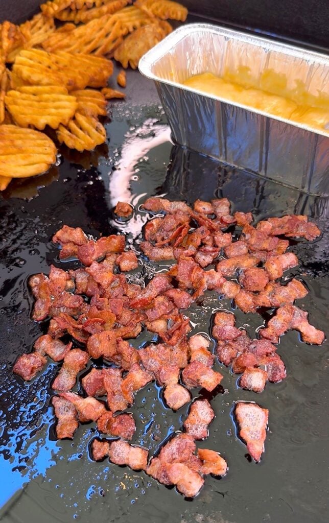cooked bacon and fries on the griddle